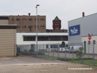 Neusser Hütte, Koppers: Wasserturm und Halle auf dem Areal des früheren Koppers Werks